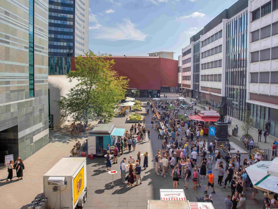 zur Vergrößerungsansicht des Bildes: Das Bild zeigt eine Aufnahme zahlreicher Menschen im Leibnizforum beim Sommerfest, Draufsicht von oben.